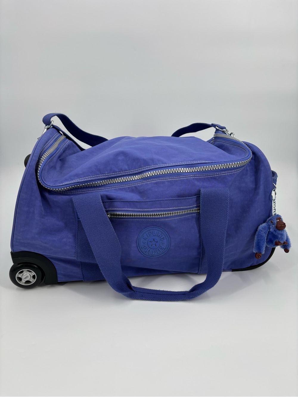 KIPLING purple rolling extension handle duffle bag with straps